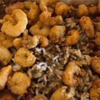 Cajun Bowl · Dirty Rice topped with red beans, crawfish tails or popcorn shrimp and our famous Cajun sauce