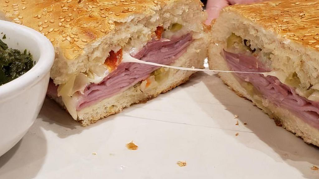 Muffuletta · Our signature crusty bread, smothered with marinated olive salad, cured ham, Italian salami, imported provolone and that special New Orleans  blend of flavors