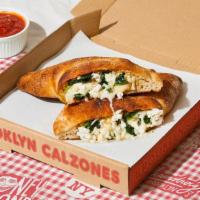 Greenpoint Calzone · Calzone with fresh spinach, garlic, burrata, melted mozzarella, and a side of marinara. (v)