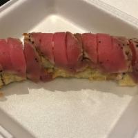 Kristy Roll (Tempura Style) · Crab stick, avocado, jalapeño, and cream cheese in tempura style, topped with pepper tuna, e...
