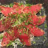 Pepper Tuna App. (8 Pcs) · Seared pepper tuna thinly sliced served with spicy ponzu sauce, cilantro and scallion on top.
