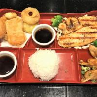 Salmon Teriyaki Bento Box · Served with miso soup salad pan-fried dumplings california roll or vegetable tempura and ste...
