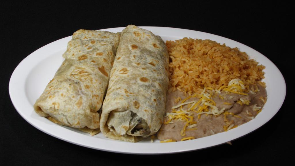 Carne Asada Burritos (2) · Inside burritos are guacamole, pico de gallo, and rice and beans on the side.