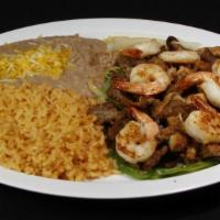 Mixed Fajitas · Steak, grilled chicken and shrimp mixed with bell peppers and onions, with rice and beans on...