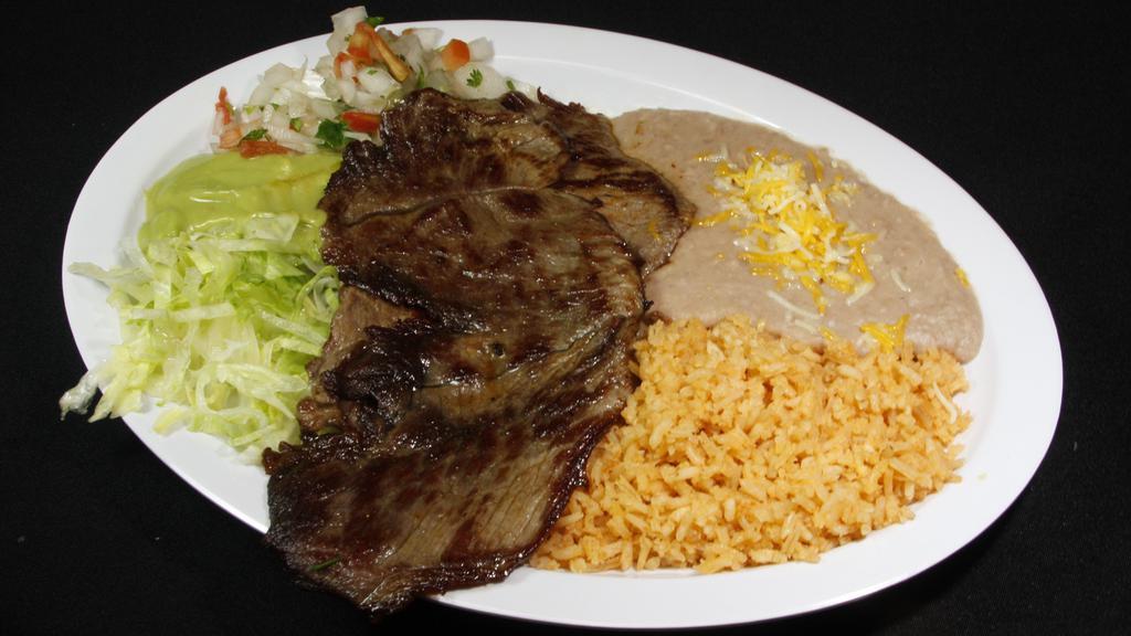 Carne Asada · Guacamole, pico de gallo, lettuce under the meat, and rice and beans on the side. Your choice of corn or flour tortillas.