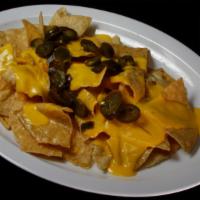 Nachos · Tortilla chips with melted queso and jalapeños on top.