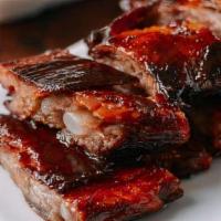 Chinese Bbq Pork Ribs · Marinated Pork Ribs slow cook to perfection. Served with our house special sauce.