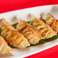 Fried Pot Stickers · Crescent-shaped pork dumplings pan-fried to a golden-brown. Served with ginger soy. dipping ...