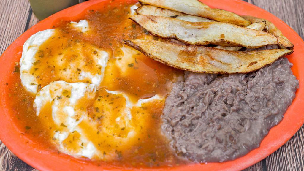 Huevos Rancheros · Three eggs with ranchero sauce on top. Accompanied with fries and Refried beans.
