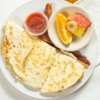 Breakfast Quesadillas · Eggs mixed with sausage, onion, tomato, green pepper, and cheeses folded in a large flour to...