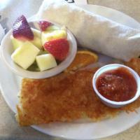 Breakfast Burrito · Eggs mixed with sausage, onion, tomato, green pepper, and cheese rolled in a large flour tor...