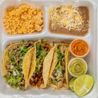 Taco Plate · Three corn or flour taco's with choice of meat, beans and rice.