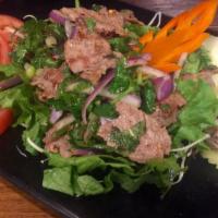 Thai Grilled Rib Eye Salad · Grilled and sliced rib eye steak with lime juice, red onion, tomato, mint, and cilantro.