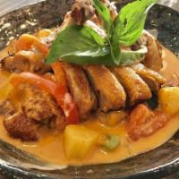Duck Curry · Roasted duck in red curry, pineapple, red and green bell peppers, and tomato.