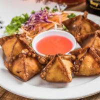 Crab Angels · Fried wontons with cream cheese and imitation crab meat served with sweet & sour sauce