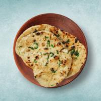 Butter Naan  · Leavened refined wheat flatbread baked in a tandoor clay oven and topped with butter.