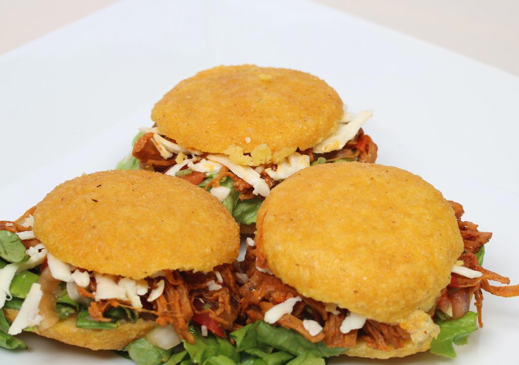 Arepitas (3Pcs) · Delicious mini fried Arepas filled with Shredded Beef or chicken, and Cheese.