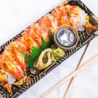 Shaggy Dog Roll · Top: kani. In: shrimp tempura and avocado. Sauce: spicy mayo and eel sauce.