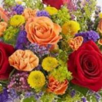 Delightful Joy · Our popular and festive arrangement has red and orange roses, orange mini carnations, yellow...