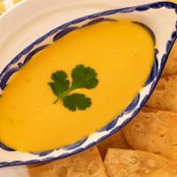 Chile Con Queso - Large · Our house made Chili con Queso, served with Chips & Salsas.