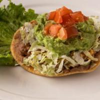 Chalupa Los Tios · Classic chalupa with refried beans, chili gravy, cheese, taco meat, lettuce, tomato & guacam...