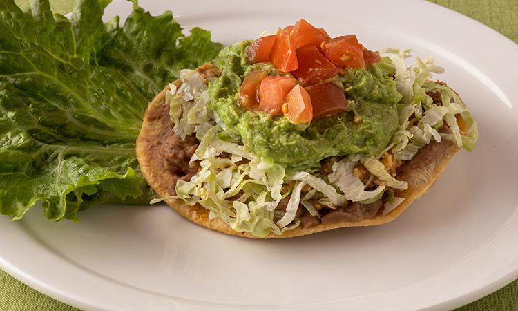 Chalupa Los Tios · Classic chalupa with refried beans, chili gravy, cheese, taco meat, lettuce, tomato & guacamole.