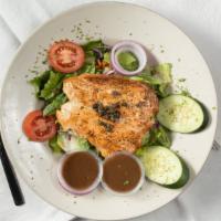 Salmon Salad · Grilled salmon over spring mixed greens, garnished with fresh cucumbers and capers.