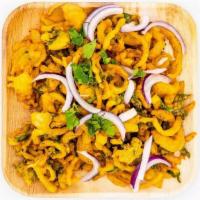 Onion Pakora · Onion slices fried with coated lentil batter and served with mint chutney
