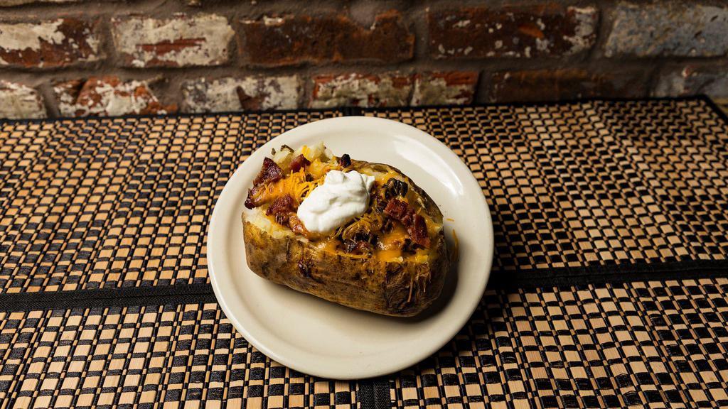 Bbq Baked Potato · Giant Idaho baked potato with cheese, sour cream, butter, and bacon and 1/3 lb of your choice of our own house smoked brisket. pulled pork or chicken.