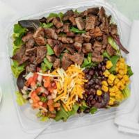 Carne Asada · Our special house seasoned grilled beef, chopped romaine lettuce, baby mix greens,roast corn...