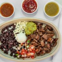 Carne Asada Bowl · Our special house seasoned grilled beef served with cilantro lime rice and black beans toppe...