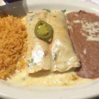 Brisket Enchiladas · Two slow smoked brisket enchiladas wrapped in flour tortillas and topped with queso.