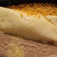 Brisket Burrito · Slow smoked brisket, mixed cheeses, Charro beans, guacamole, pico de gallo, and avocado chip...