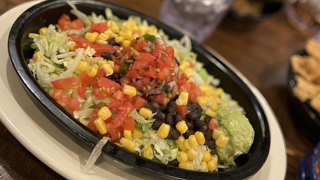 Burrito Bowl · Mexican rice, charro or black beans, shredded lettuce, pico de gallo, corn and your choice of grilled chicken, fajita beef or brisket. All topped with mixed cheeses, scoops of sour cream, and guacamole.