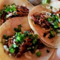 Brisket Tacos · Two slow smoked brisket tacos with flour tortillas. Served with spicy Mexican cole slaw, avo...