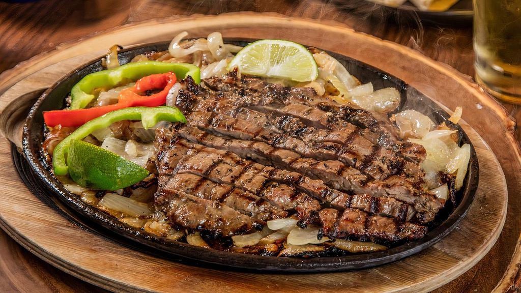 Beef Fajita · Served sizzling hot on a bed of sauteed onions and bell peppers, with refried beans, Mexican rice, flour tortillas, sour cream pico de gallo, and choice of cheese or guacamole.