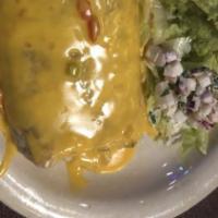 Burrito Ranchero · Comes with ranchero chicken refried beans topped with meat gravy and CCQ.