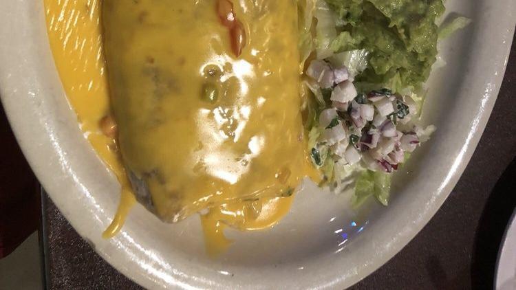 Burrito Ranchero · Comes with ranchero chicken refried beans topped with meat gravy and CCQ.