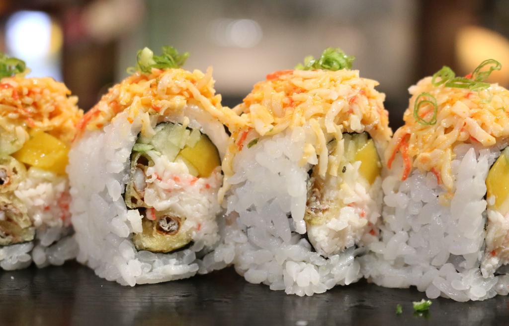 Amazing Spider Roll · Mango, soft shell crab, crab meat, cucumber, avocado topped with spicy crab meat and yuzu sauce and scallions