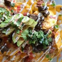 Nachos Supreme · Chips topped with our special nacho cheese, mozzarella, beans, jalapenos, diced tomatoes, av...