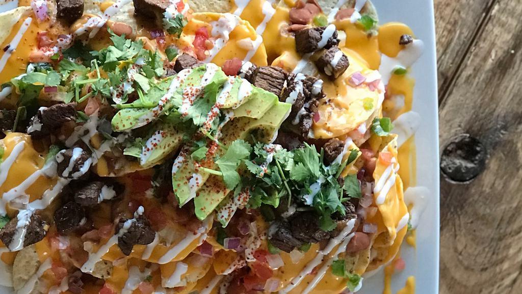Nachos Supreme · Chips topped with our special nacho cheese, mozzarella, beans, jalapenos, diced tomatoes, avocado, onions, Mexican style cream and your choice of beef, chicken or shrimp. Upgrade to your favorite chips).