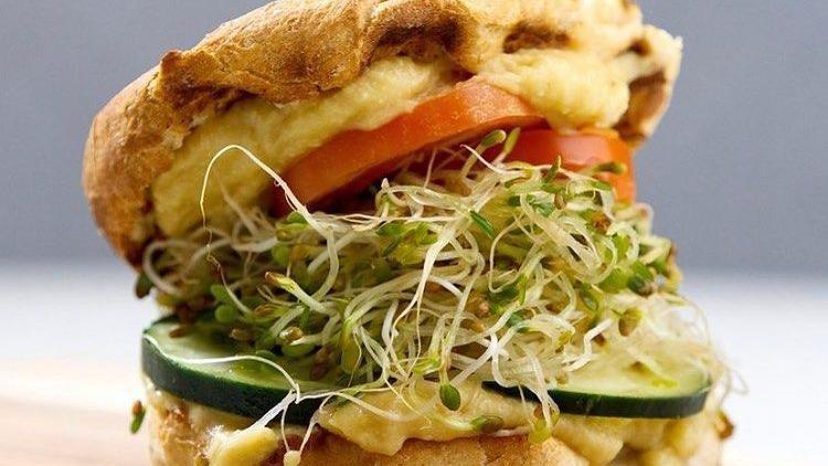 Cheesy Veggie Sandwich · Scrambled tofu, smoked tempeh, fresh tomato, red onion and spicy cashew sriracha.