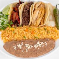 Mi Special · Three tacos corn or flour tortillas choice of meat served with rice and beans.