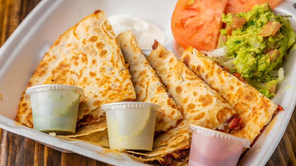 Quesadilla · Melted white and yellow cheese with any of your choice of meat. Served with a side of lettuce, pico de gallo, sour cream and fresh guacamole.