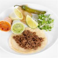 Tacos · Corn or flour tortilla with cilantro and onions, grill onions, jalapeño, and lime on a side.