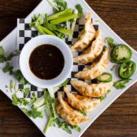 6 Gyoza · Pork or Chicken dumplings pan-fried and served with ginger soy dipping sauce.