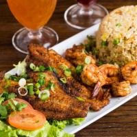 Blackened Seafood · Seafood blackened in cajun spices with a rich butter sauce, lettuce, and tomato. Served with...