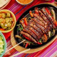 Bbq Beef Fajitas · 2 large Fajitas  - BBQ Texas longhorn beef,  onions, bell peppers
This plate comes with Span...