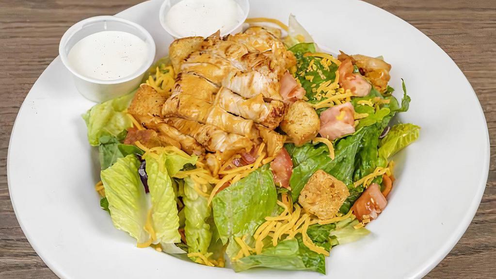 Grilled Chicken Salad · Tossed green salad with shredded cheese, tomatoes, and croutons, topped with a marinated, grilled chicken breast. Choice of dressing.
