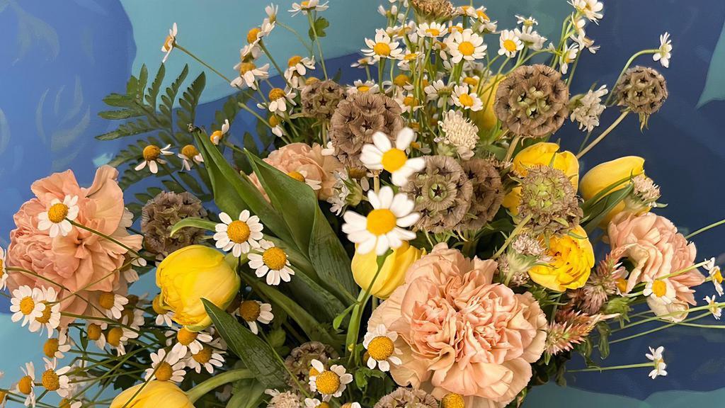 Hand Tied Bouquet · Featuring chamomile and yellow double tulips, this hand tied bouquet is sure bring a smile to Moms face with all of its texture!